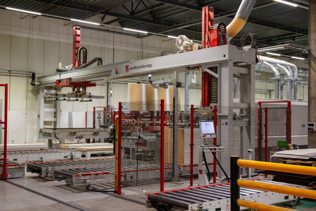 Industrial machinery with robotic arm in a modern manufacturing facility.